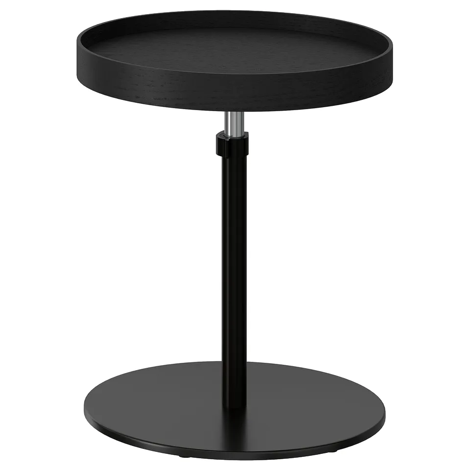 A black TRANERED adjustable side table with a round top and base, perfect for sofa use.