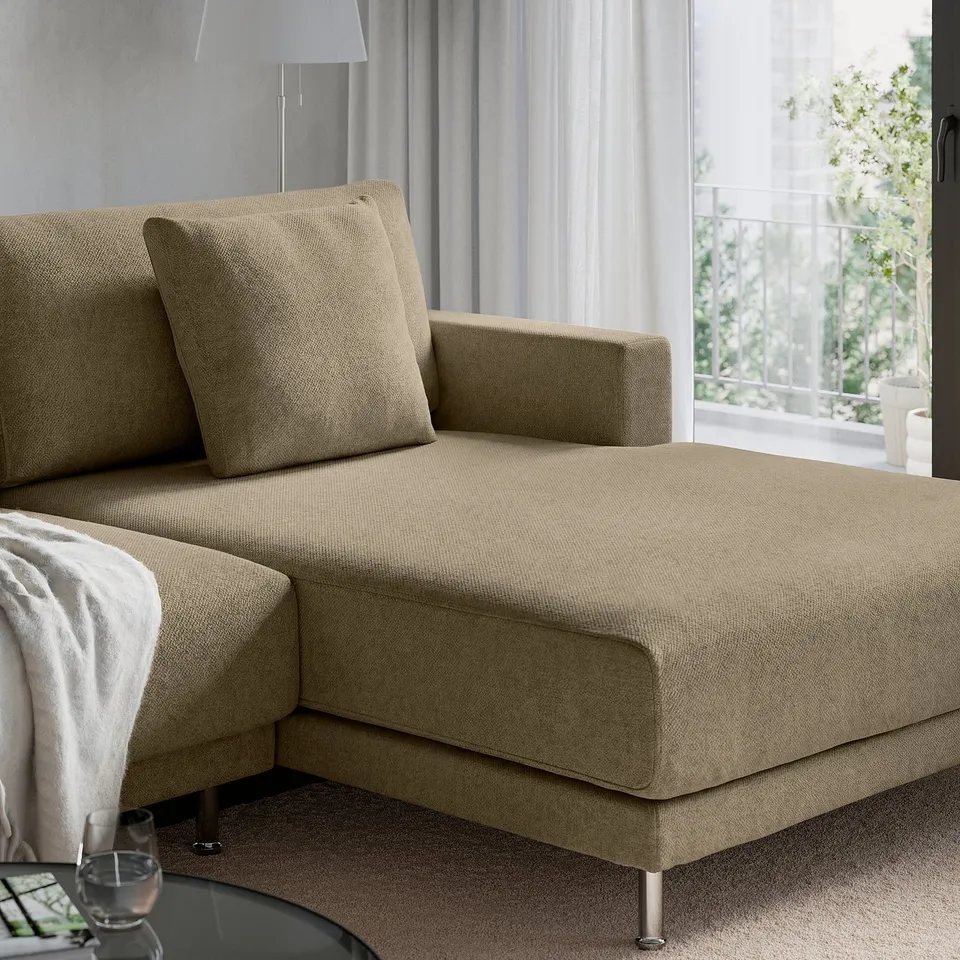 UPPÅKRA sofa with beige cushions, large backrest, armrest, and footrest; set near window with curtains.