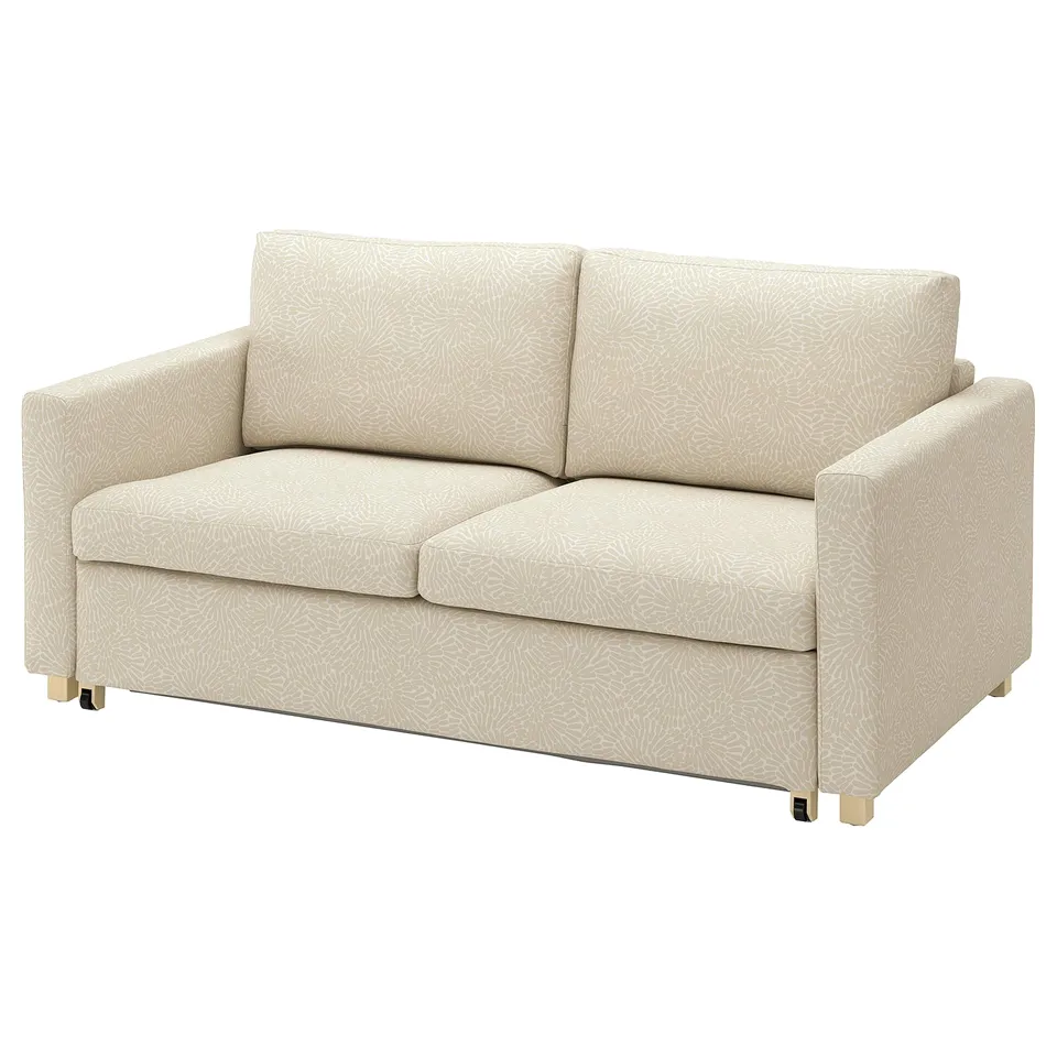 A beigecolored SALTSJÖBADEN sofa with light floral pattern, featuring cotton and polyester fabric, raised legs, and comfortable cushions.