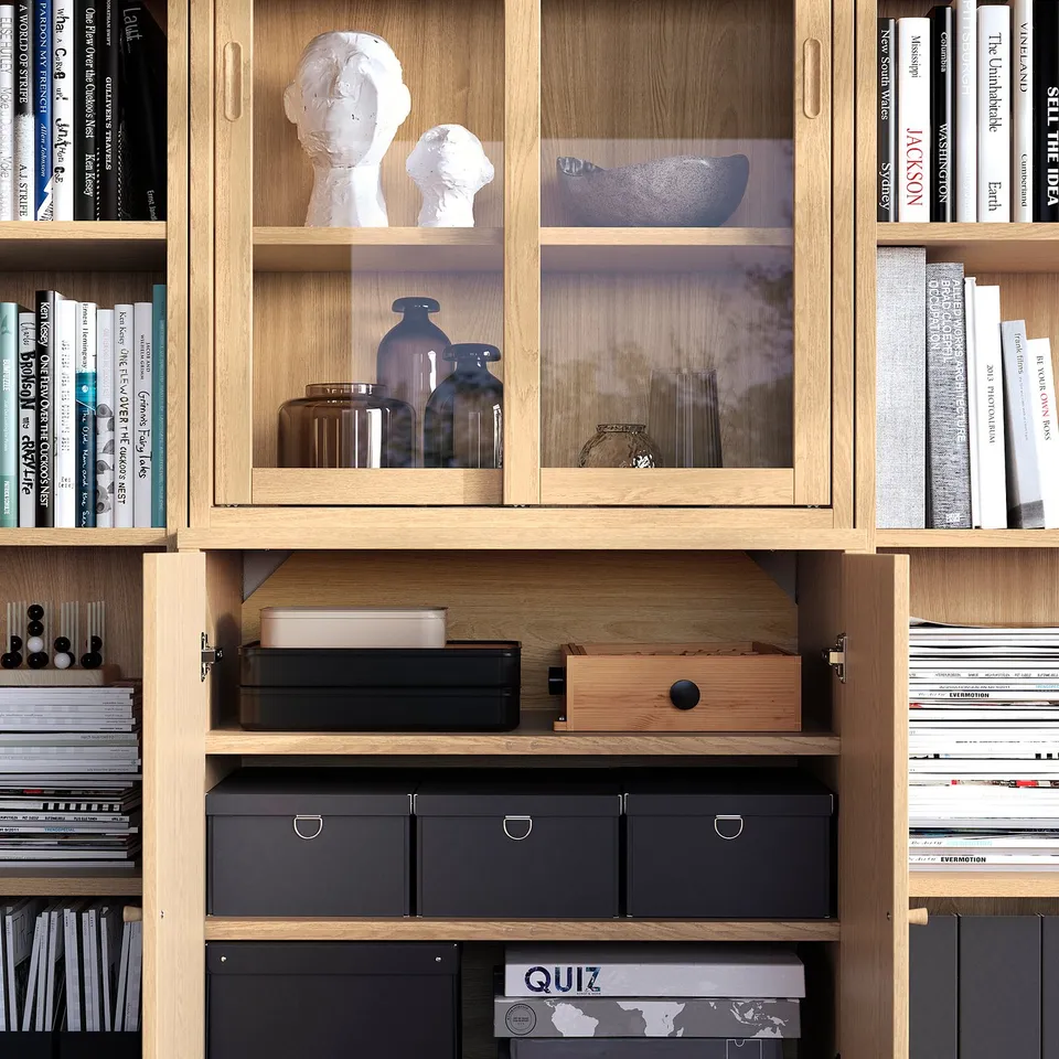 Wooden bookshelf with glass doors showing both hidden and open storage, combining shelves for books and decorative items.