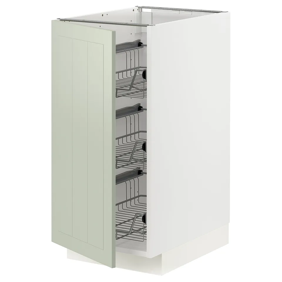 A METOD kitchen cabinet in green with organised interior shelves.