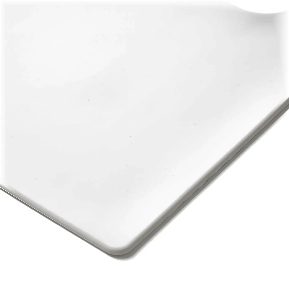 Image shows a white, smooth, sleek edge of a place-mat, highlighting its minimalist design.