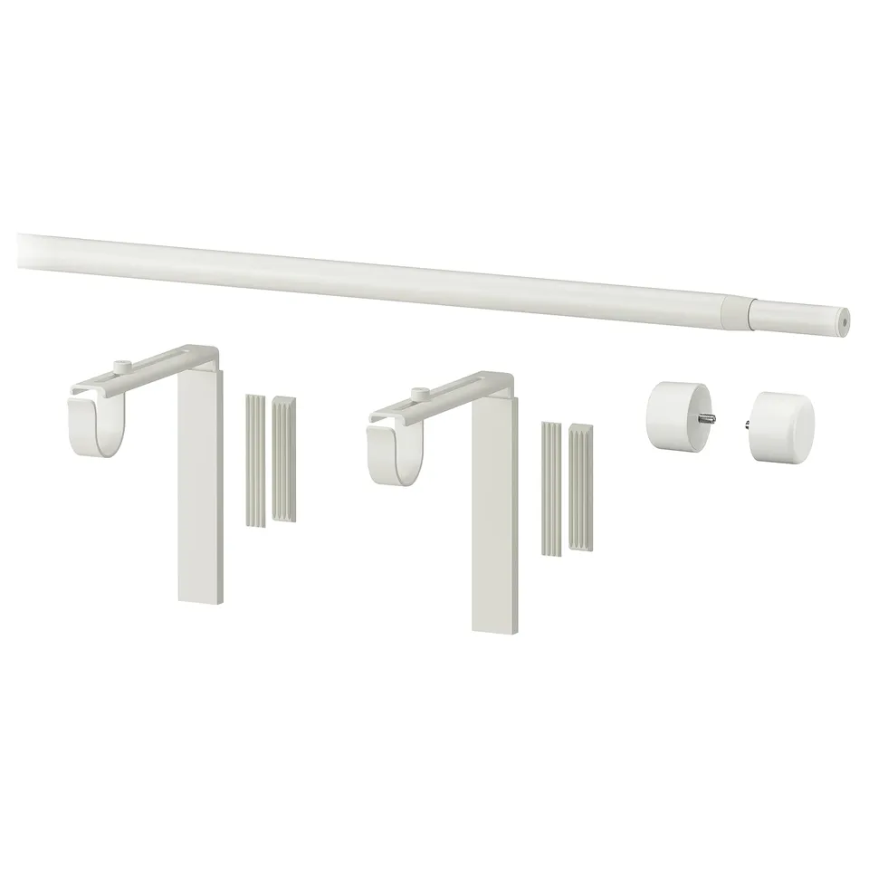 A white RÄCKA curtain rod set including an extendable rod, two brackets, and two finials, all made of steel and plastic.