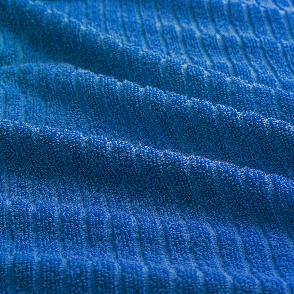 Blue towel with soft, plush texture; appears absorbent and durable, ideal for bath use.