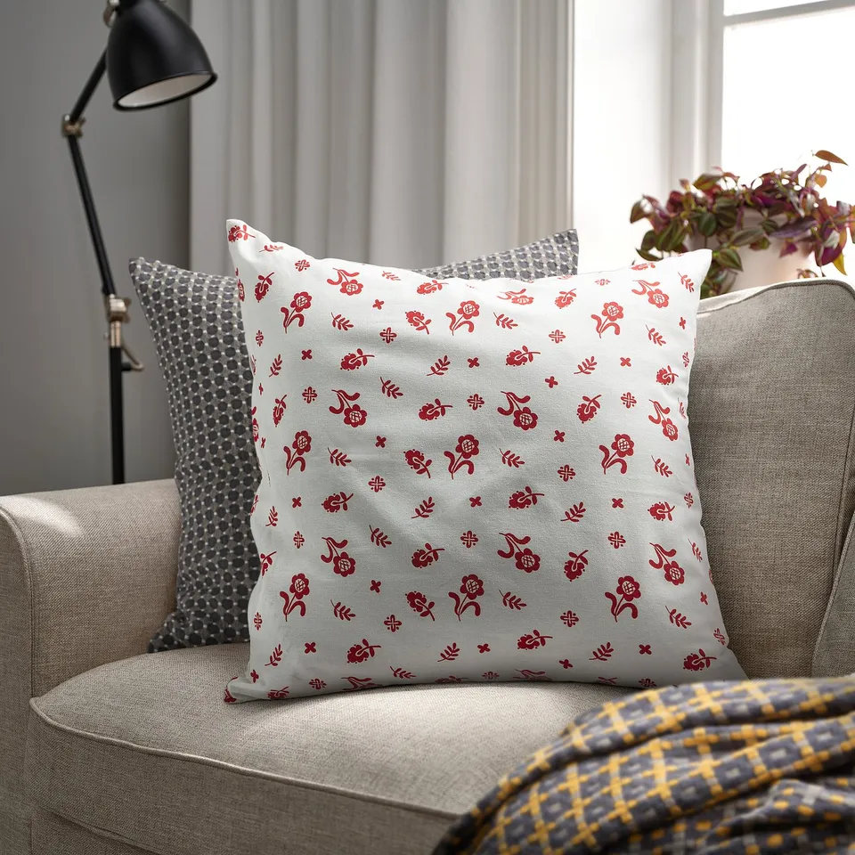 Decorative living room with TÅGSÄCKMAL cushion, floral pattern on beige. Large, square, fits well on chair.