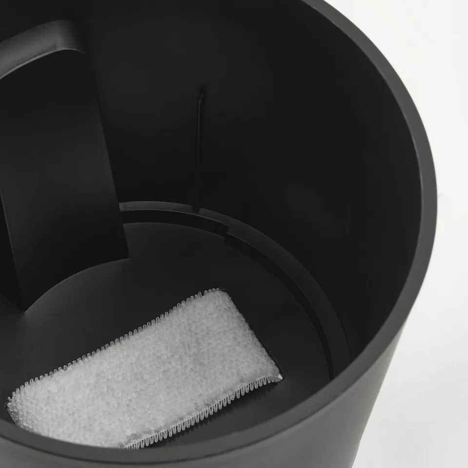 Self-watering planter with triangular wick for easy plant care.