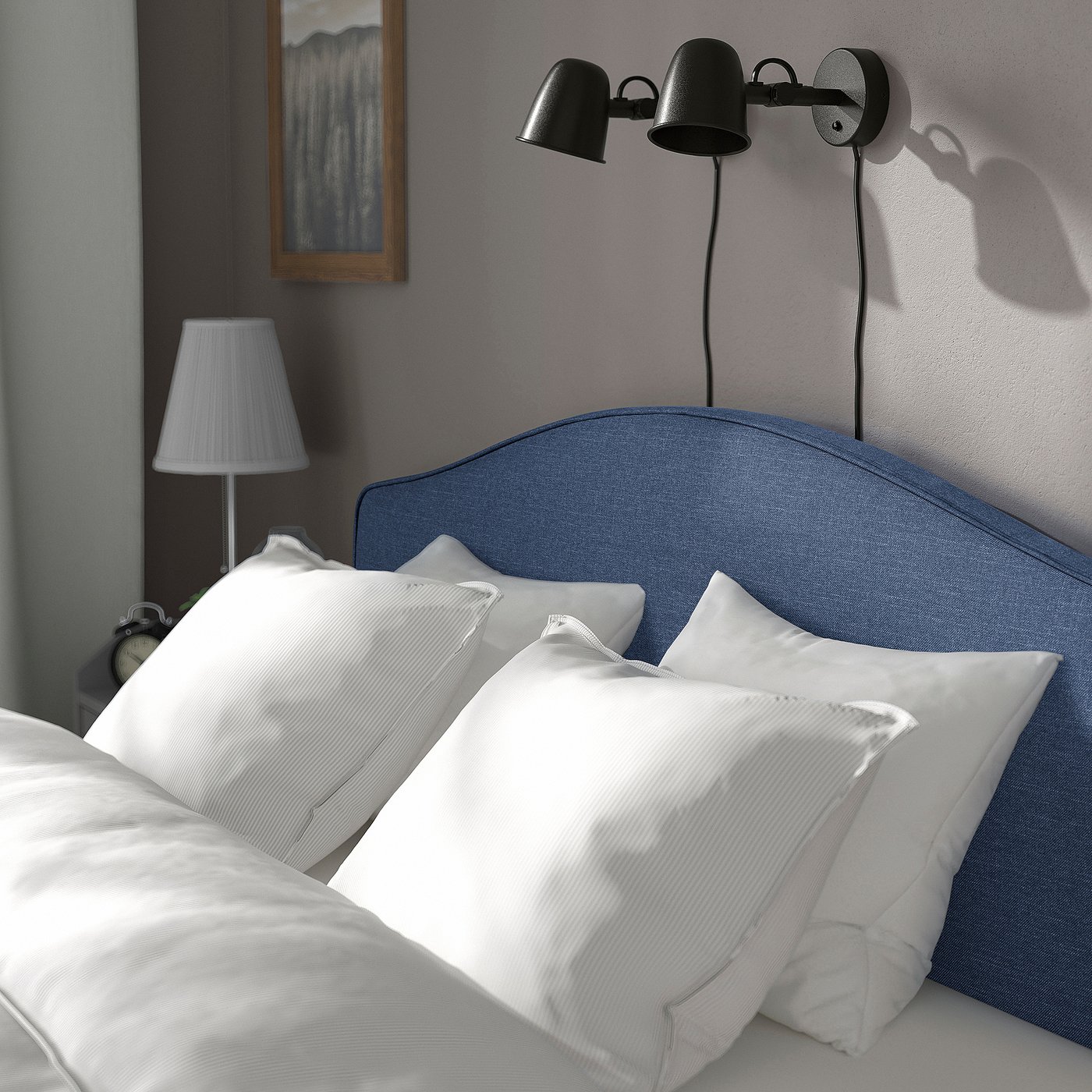 Bedroom scene with a blue RAMNEFJÄLL bed, white pillows, and wall-mounted black light fixtures.