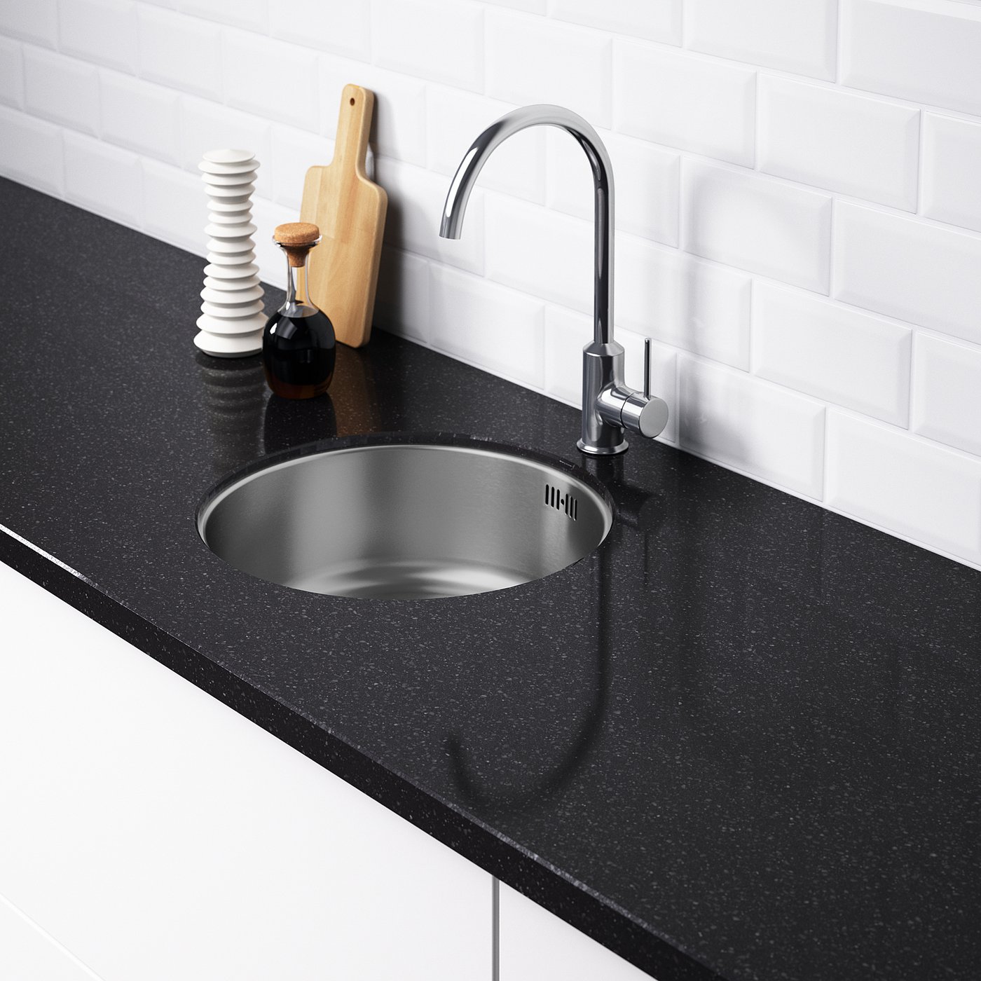 Modern kitchen sink with chrome tap and black countertop. Stainless steel sink, no pre-drilled holes. White tiled backsplash.