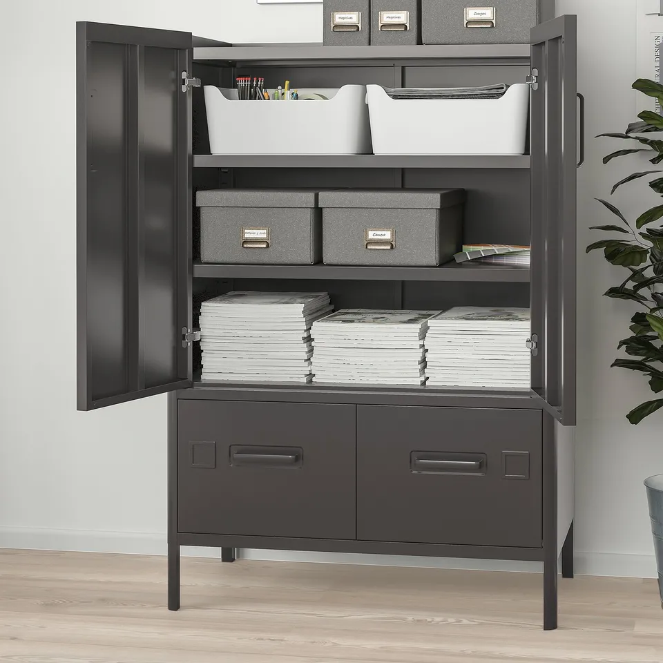 Black metal storage cabinet with two open doors revealing organised stacks of paper, boxes, and a bin of supplies. Also two drawers.