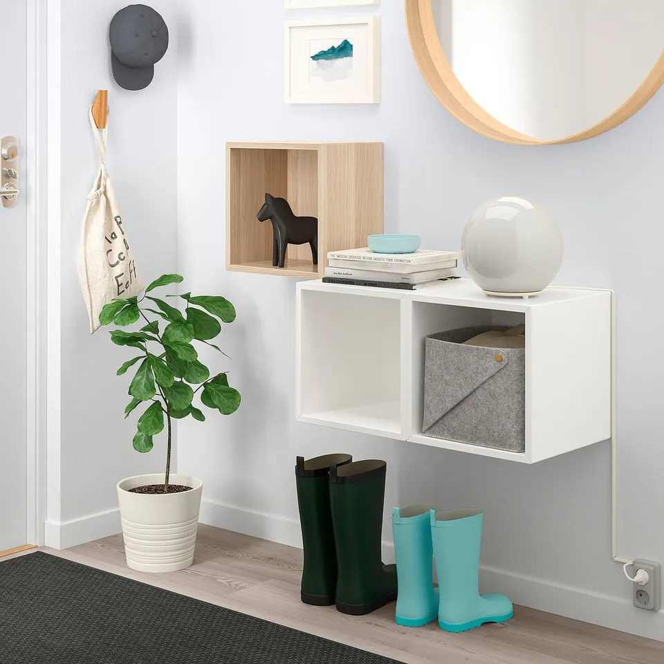 EKET wall cabinet with books, boxes, horse, boots, plant & mirror.