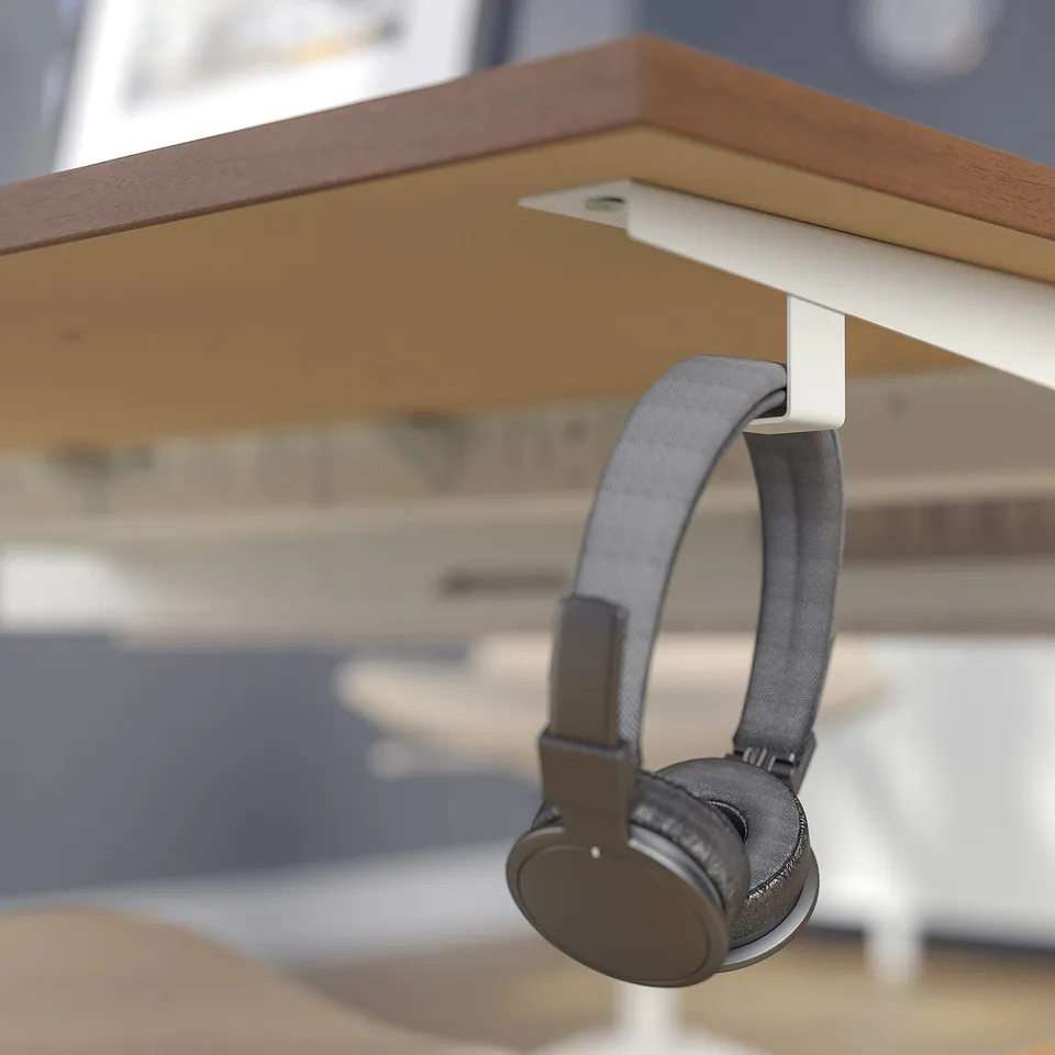 Headphones on desk hook under table.