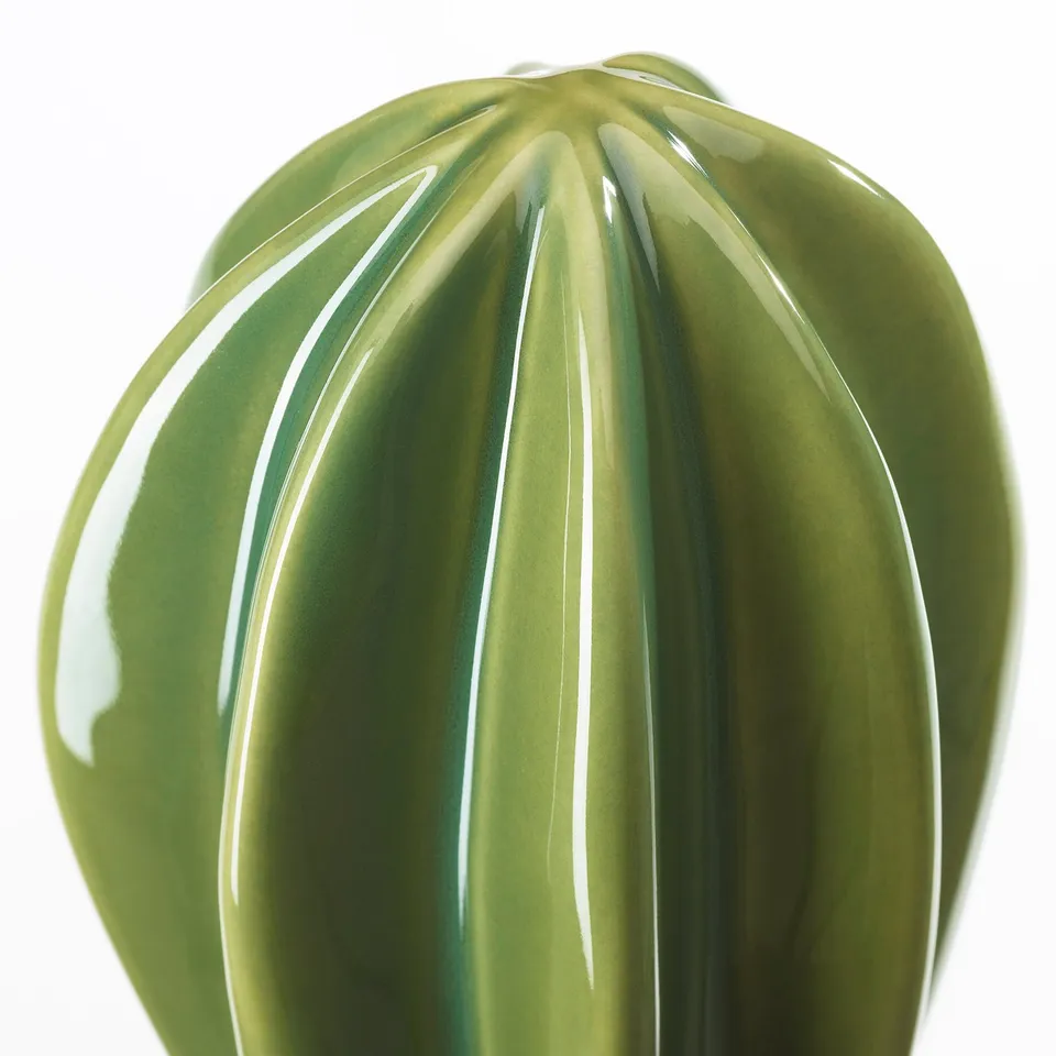 Green vase with vertical ridges, high craftsmanship.