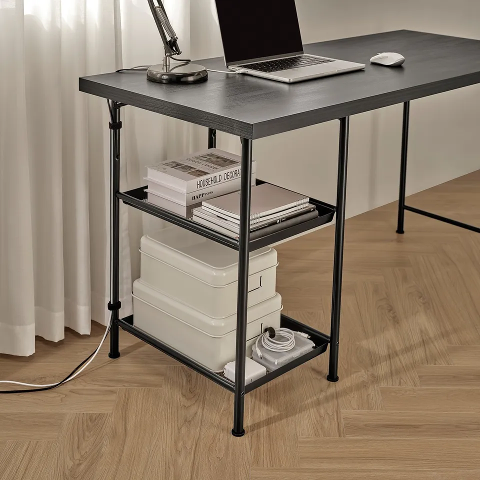 Modern desk with two shelves holding books, boxes, and a laptop. Cable management net visible on bottom shelf.