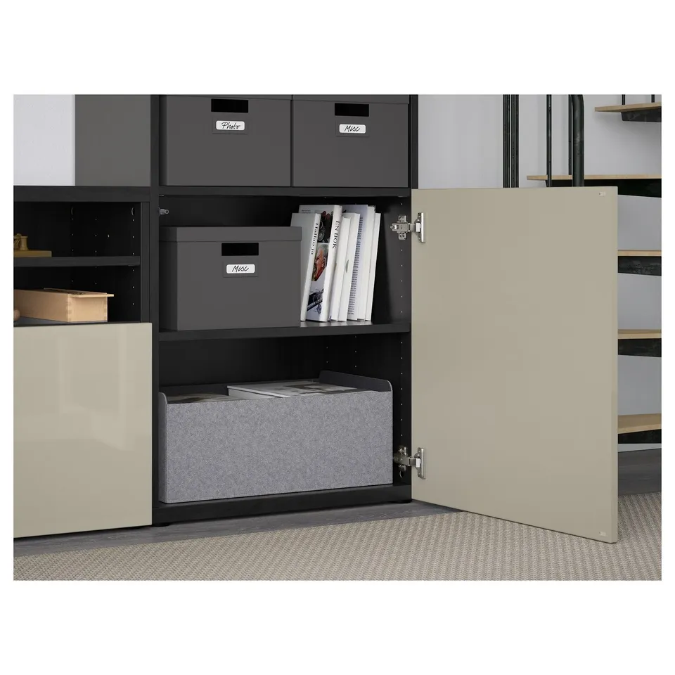 Open BESTÅ cabinet reveals adjustable shelves and storage boxes, with a soft-closing door.