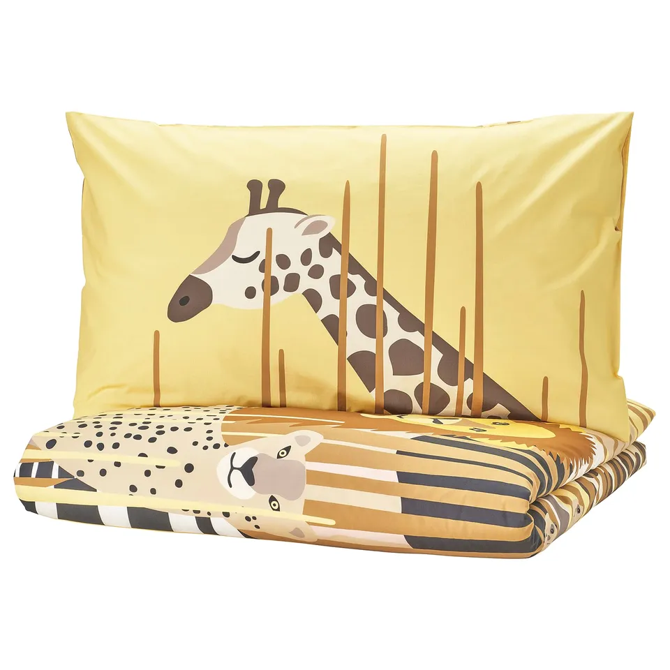 Safari-themed bedding set: yellow pillow & duvet cover featuring playful giraffe, zebra, cheetah, and elephant.