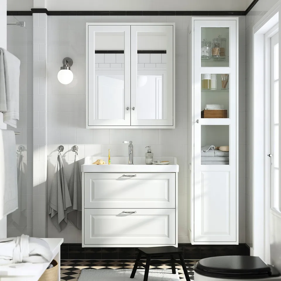 White TÄNNFORSEN bathroom vanity set with storage cabinets and wall-mounted ceramic sink.
