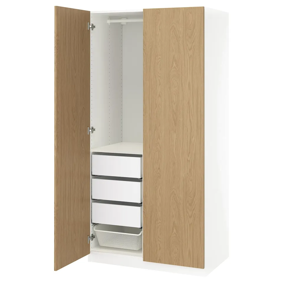 Modern white and oak PAX wardrobe, open showing drawers and shelves.