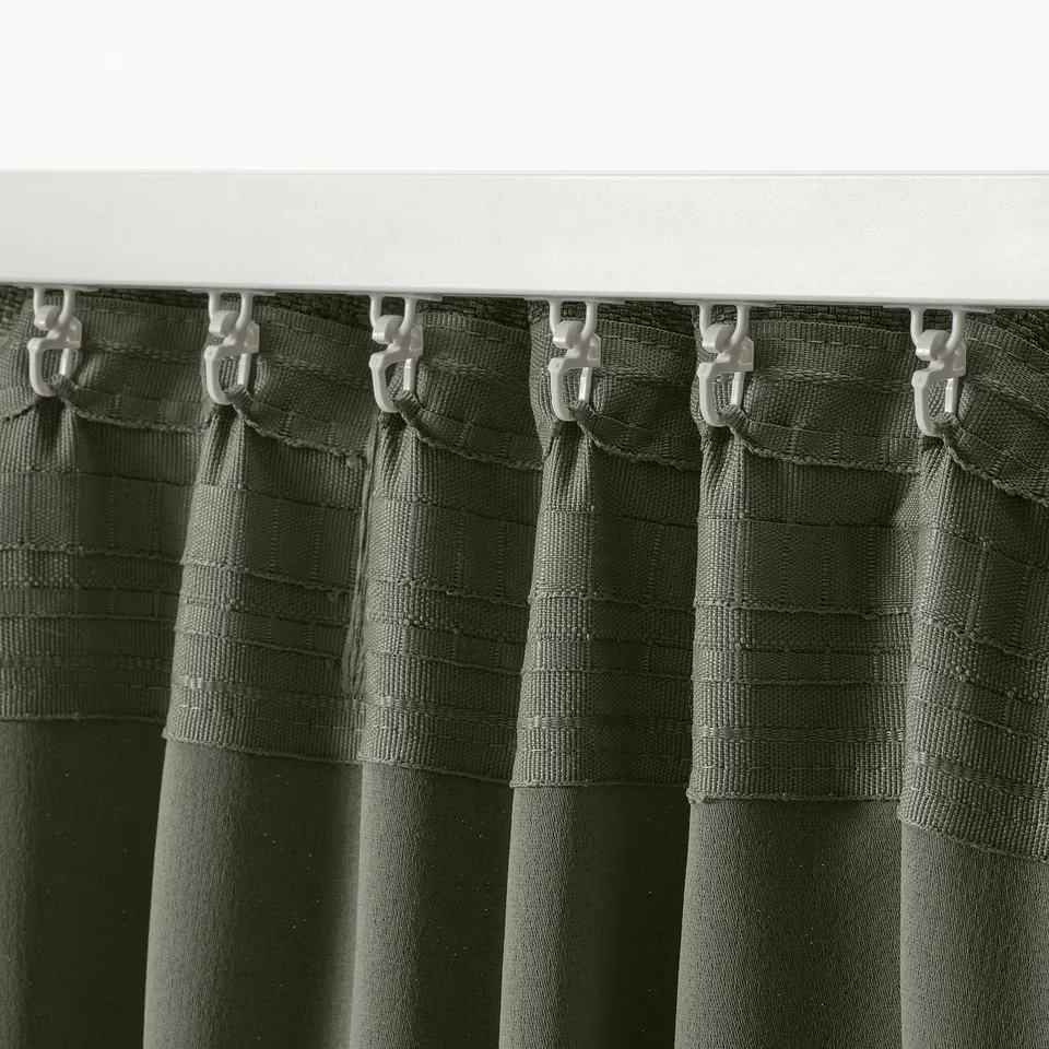 Dark green curtains with hook system for easy pleating, designed for thermal and light control.