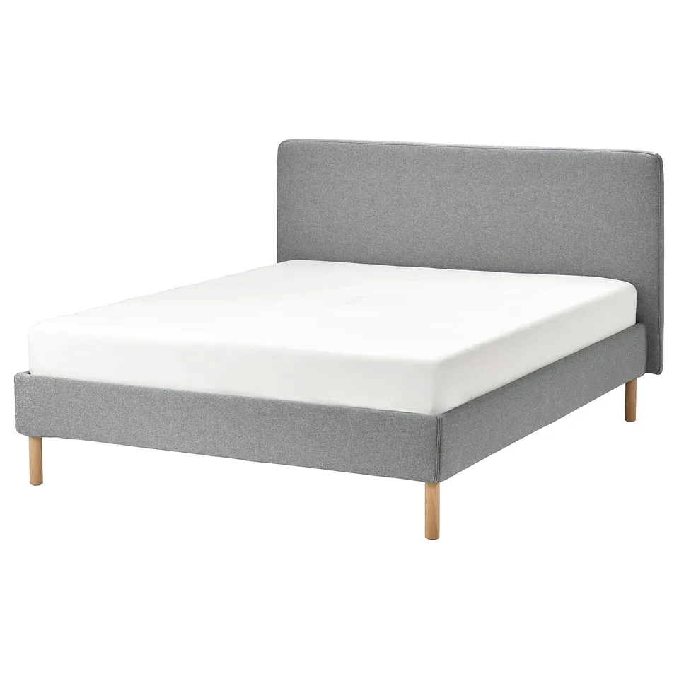 A modern grey bed with a removable fabric cover, wooden legs, and a soft headboard.