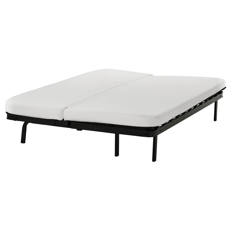 A white NYHAMN foam mattress with a black metal frame, designed for a sofa-bed, featuring a removable cover for machine washing.