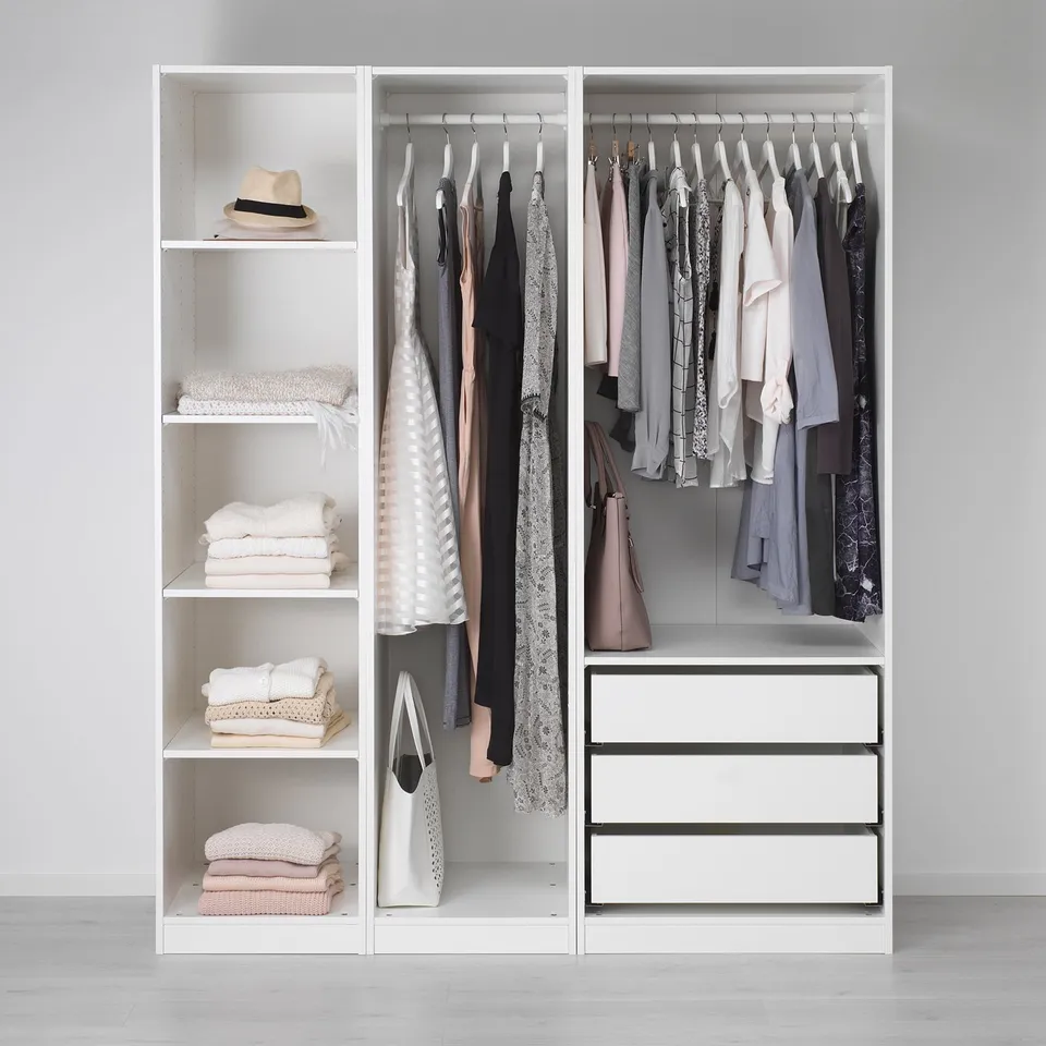 PAX closet organiser with shelves, drawers, and hanging space for clothes.