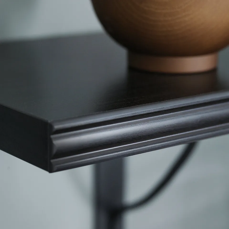 Brown-black shelf with bevelled edge, part of BERGSHULT collection, modern minimalist design.