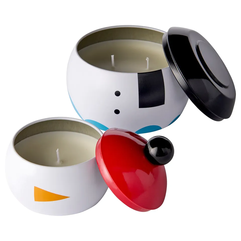 Two holiday-themed candles: one snowman, one bird, white/red, tin steel, mint scent, stacked design.
