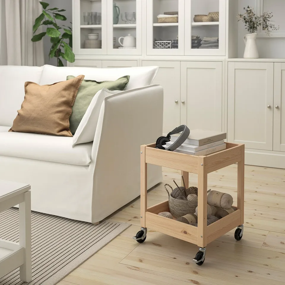 White LOSHULT trolley with wheels, holding headset, knitting supplies, fitting under couch.
