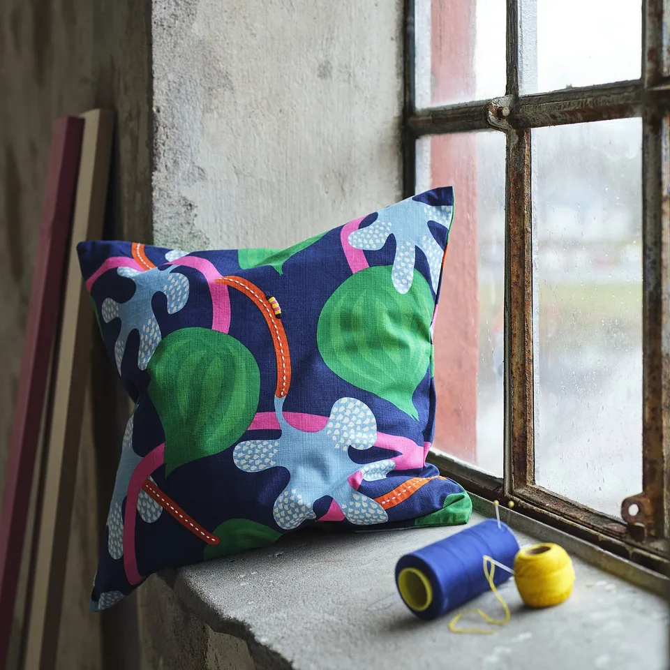MÄVINN cushion on window sill with sewing items