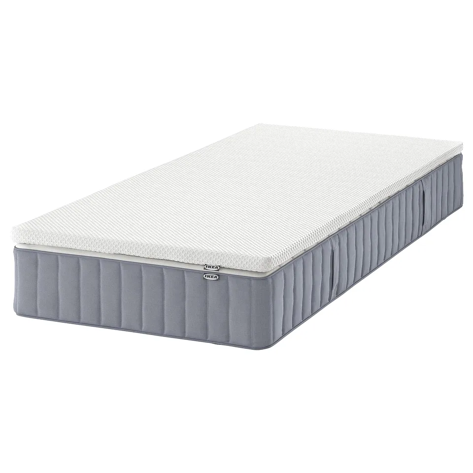 IKEA VALEVÅG pocket spring mattress. White, grey, rectangular. Foam and metal construction. Brand labels visible.