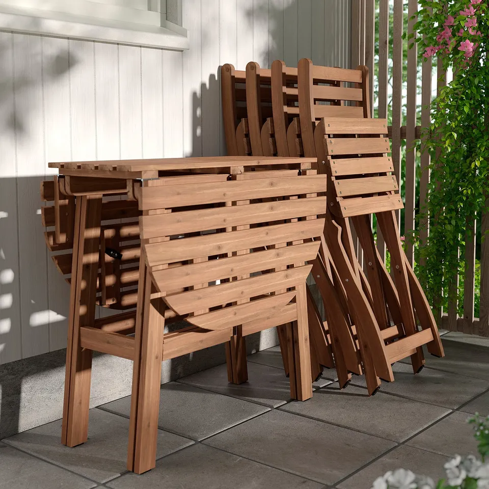 Foldable wooden garden chairs stacked neatly for space-saving. Ideal for balconies or gardens. Pre-assembled for immediate use.