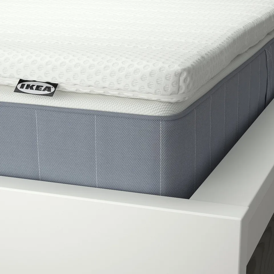 Close-up of IKEAs vesteroy mattress, showcasing its quality craftsmanship with visible stitching and a textured, breathable surface.