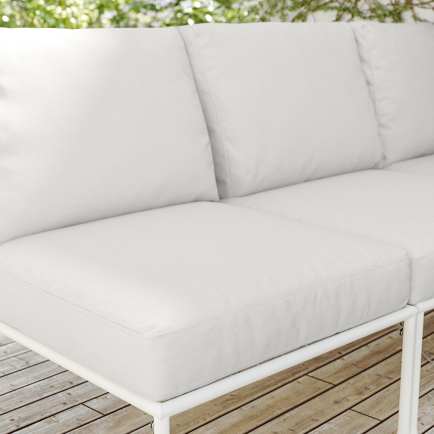 White outdoor sofa with light grey cushions, modern metal frame.