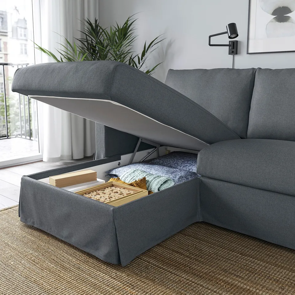 Modern grey sofa with chaise, showcasing open storage space. Ideal for keeping blankets and games.