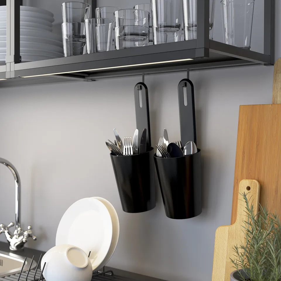 Kitchen utensil hooks hold containers under cabinet.