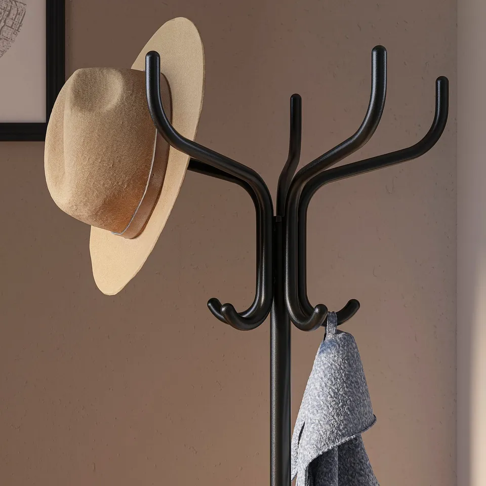 Black hat and coat stand holds hat and jacket. Functional design with hooks for easy storage.