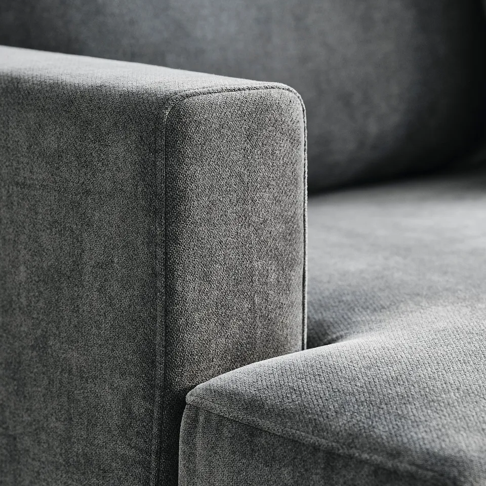 Noteworthy sofa with plush, textured fabric, designed for comfort and durability. Square cushions suggest modern design. High-quality craftsmanship.