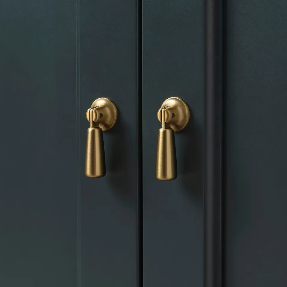Dark blue cabinet with sleek gold handles, modern and stylish.