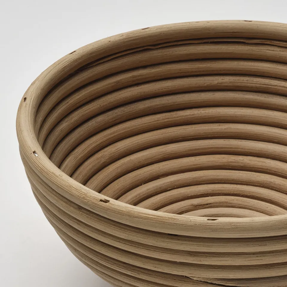Rattan basket detail, circular weave pattern, natural texture.