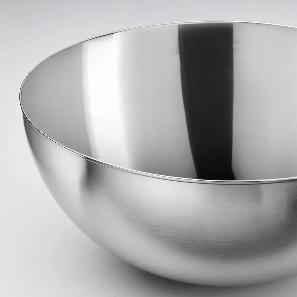 Stainless steel bowl, sleek and polished, reflects light, high quality, durable material.