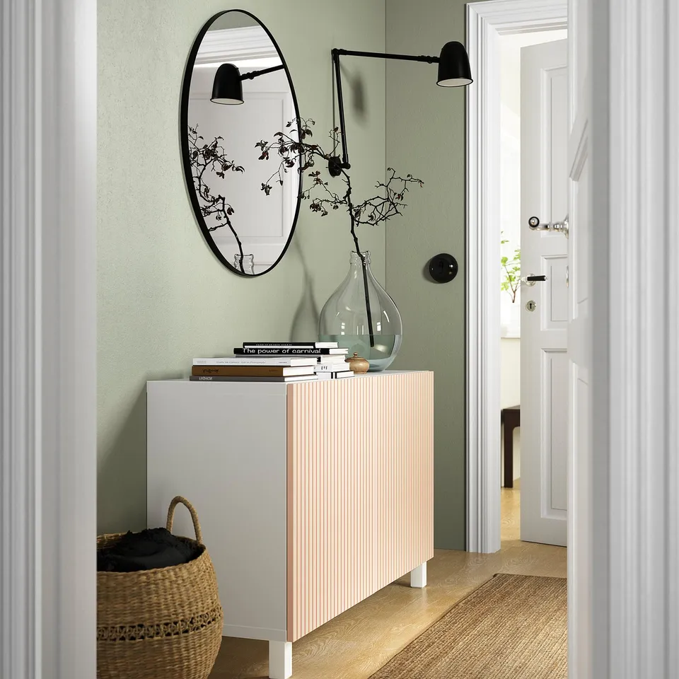 Modern entrance with BESTÅ sideboard, books, vase, mirror & lamp. Basket and hallway.