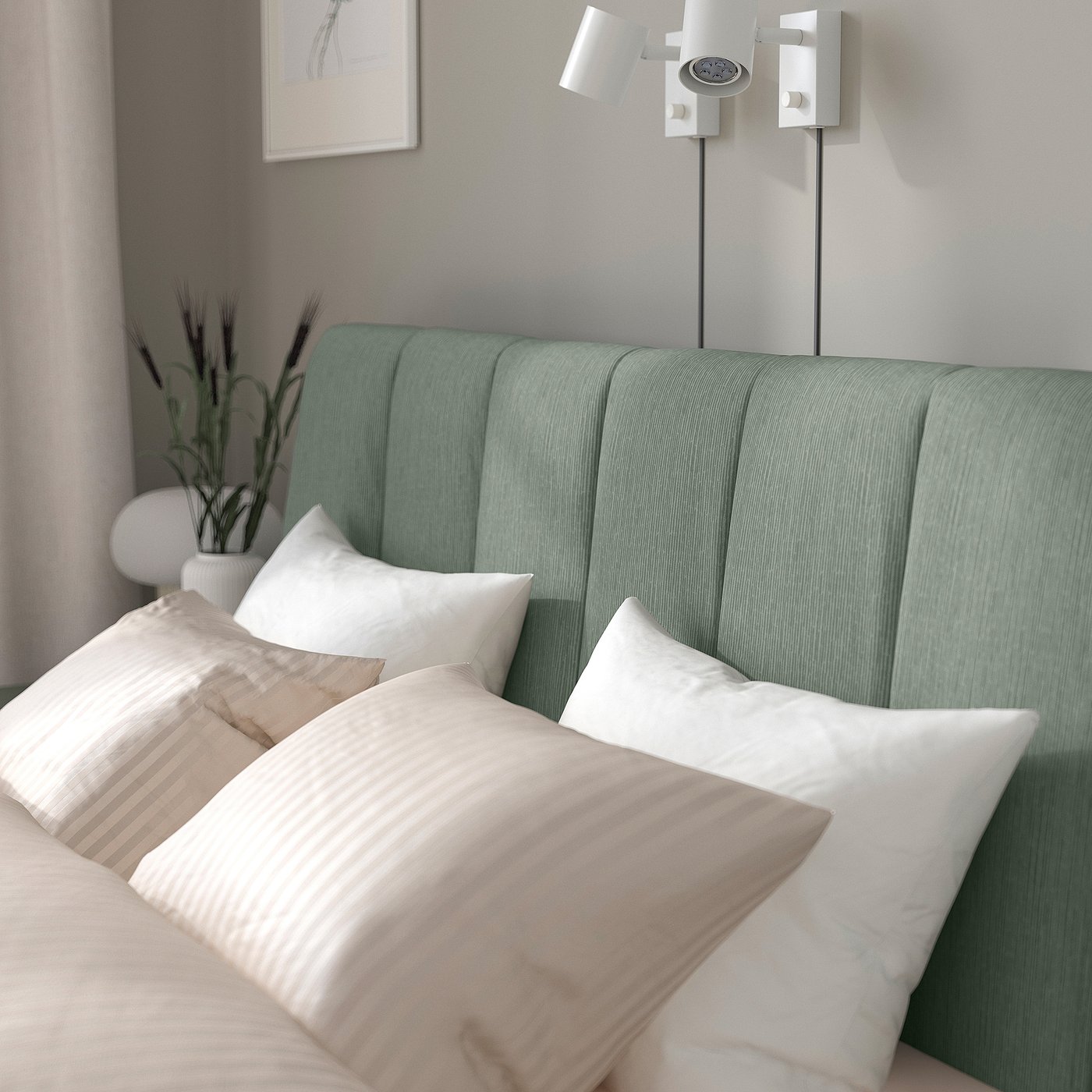 Modern green bed with white pillows, adjustable bed sides, padded headboard, and wall-mounted bedside lights.