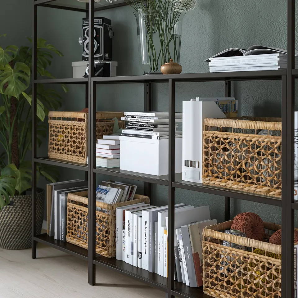 Bookshelf with woven baskets, books, and decorative items.