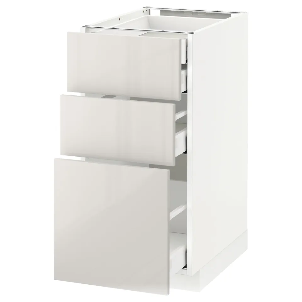 A white METOD kitchen cabinet with three drawers, modern and sleek.