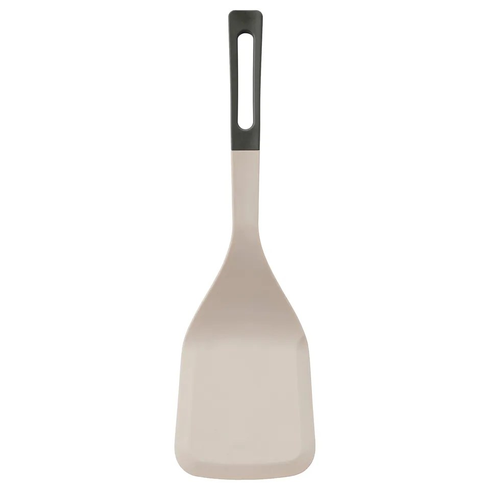 A KNORRHANE spatula in beige with a black handle, featuring a soft silicone tip and an ergonomic design for flipping and serving food.