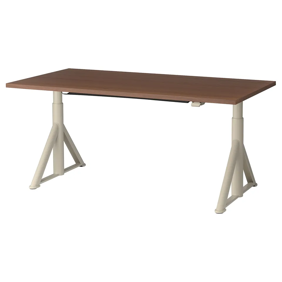 An idasen adjustable brown wooden desk with white metal legs.