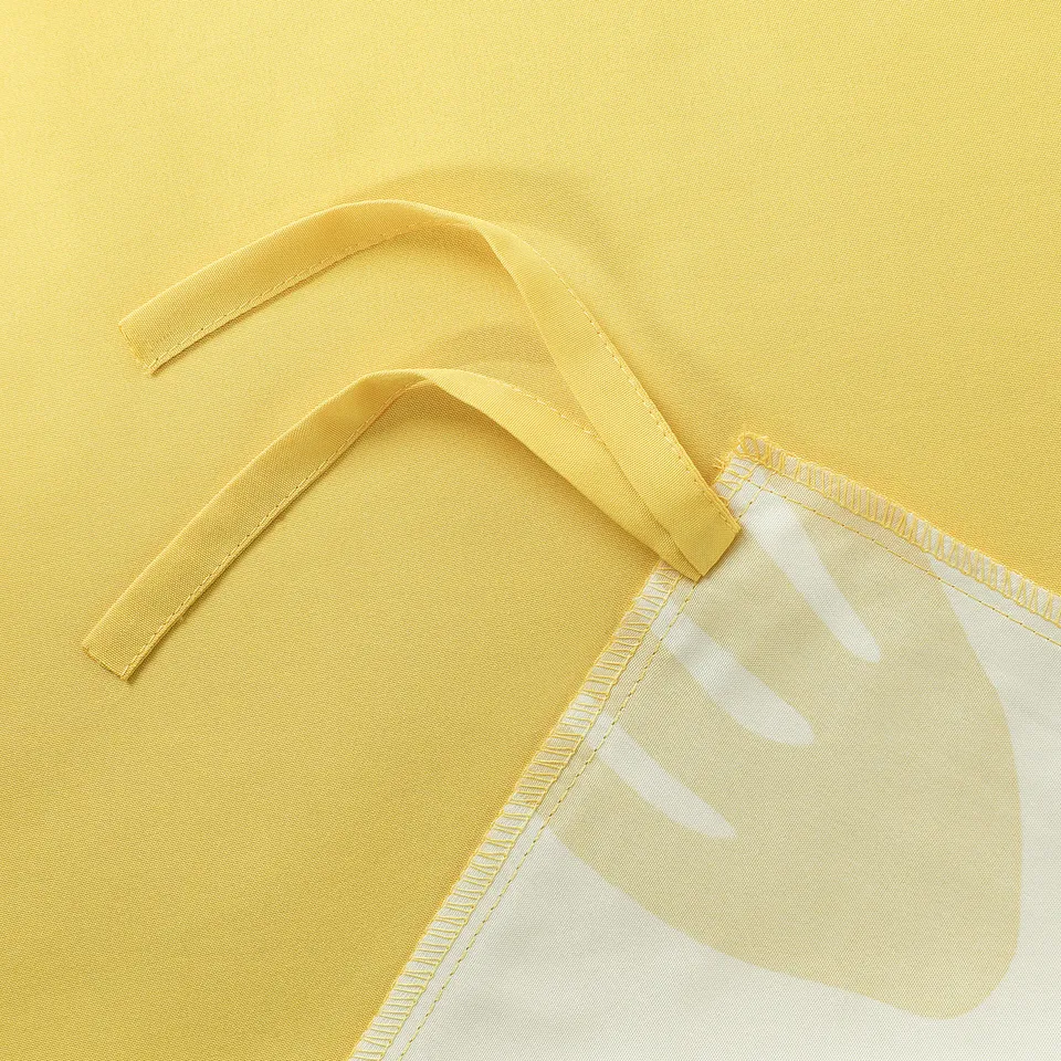 Yellow bed sheets corner with ties and tag.