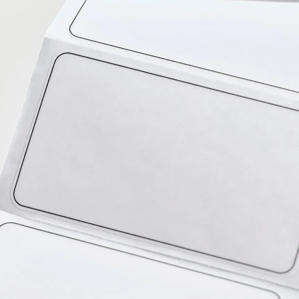 A close-up smooth, high-quality transparent plastic labels. The labels are neatly stacked, showing precision edges and clarity in design.