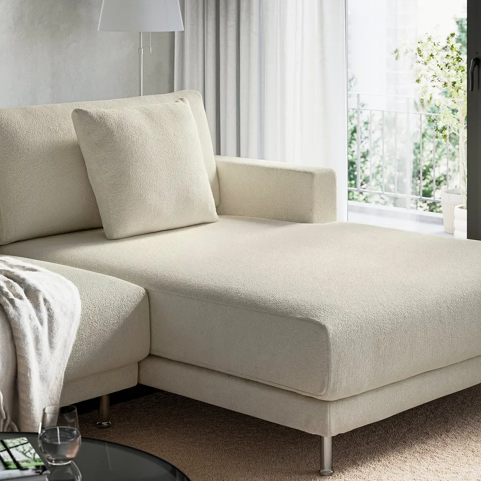 A modern, cream-colored sectional sofa with a chaise lounge, perfect for relaxing and family time.