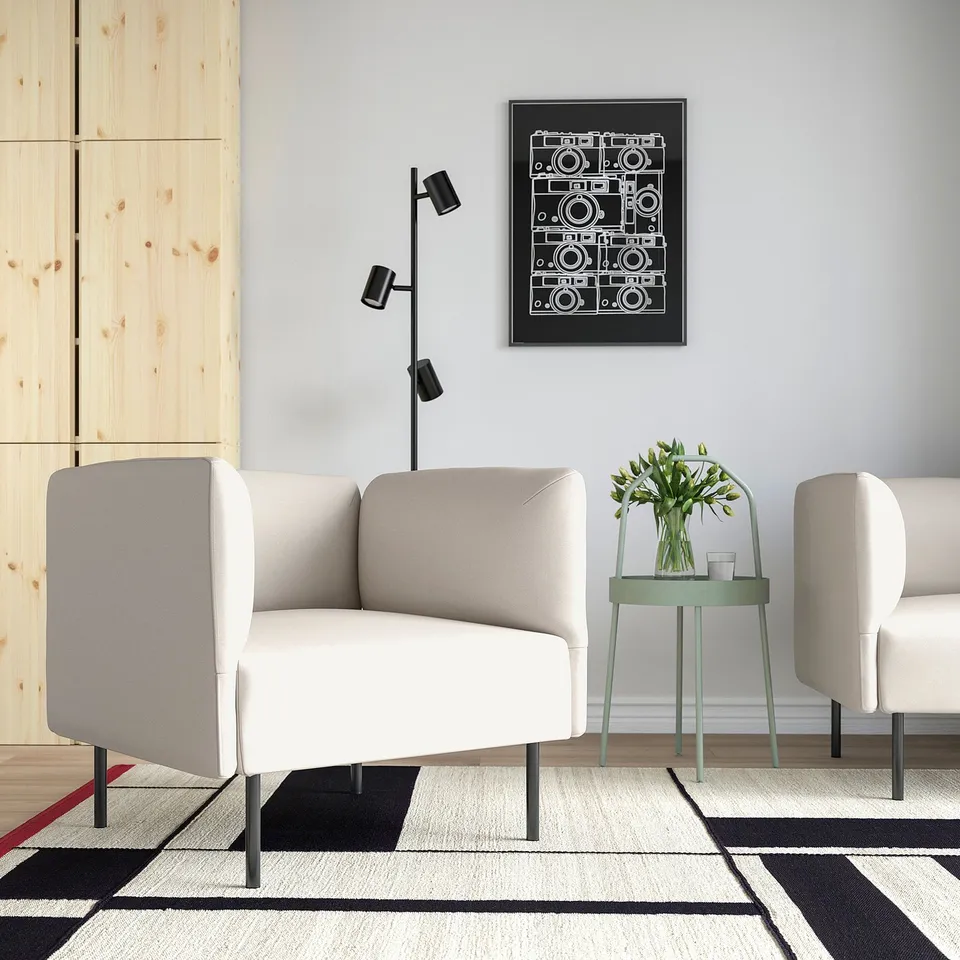 LILLEHEM white modular sofa, minimalist space, geometric rug, green side table, black/white art.